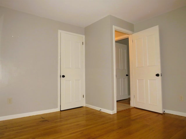 unfurnished bedroom with hardwood / wood-style flooring