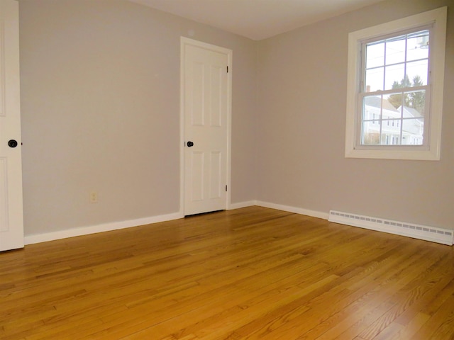 spare room featuring light hardwood / wood-style flooring and a baseboard heating unit