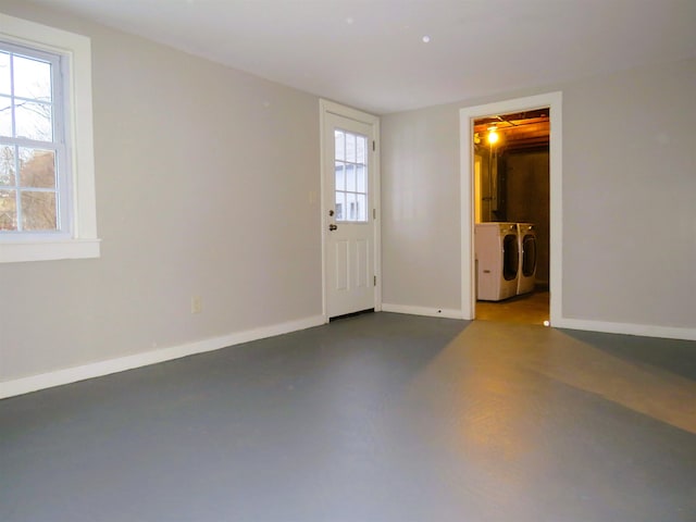 empty room featuring concrete floors and separate washer and dryer