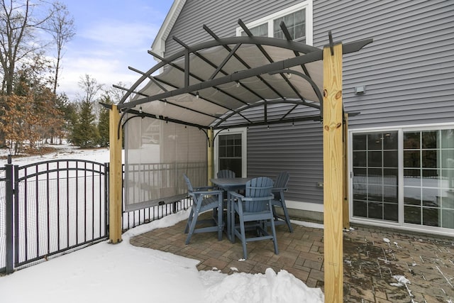 snow covered patio with a pergola