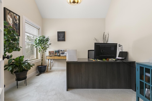 office area with light carpet and vaulted ceiling