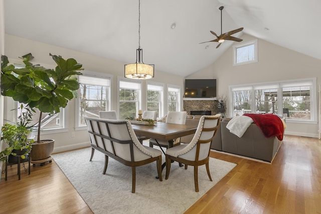 dining space featuring ceiling fan, light hardwood / wood-style flooring, and lofted ceiling