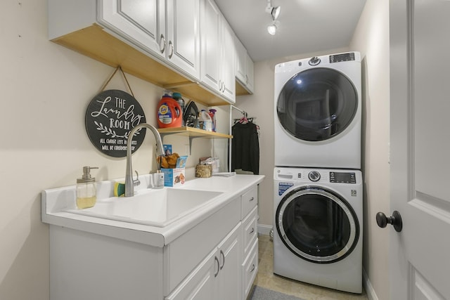 clothes washing area with sink, cabinets, and stacked washer / dryer