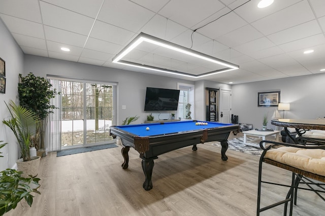 game room with hardwood / wood-style flooring, a drop ceiling, and billiards