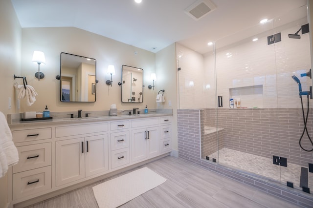 bathroom featuring vanity, lofted ceiling, and walk in shower