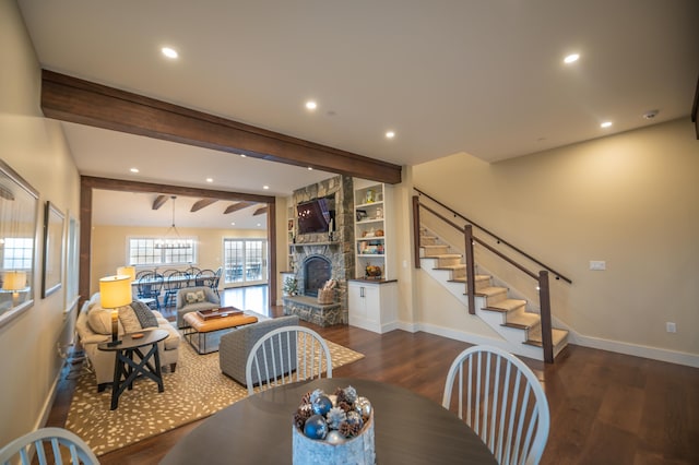 dining room featuring beam ceiling, a fireplace, and dark wood-type flooring