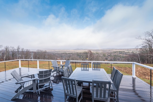 wooden terrace with a lawn