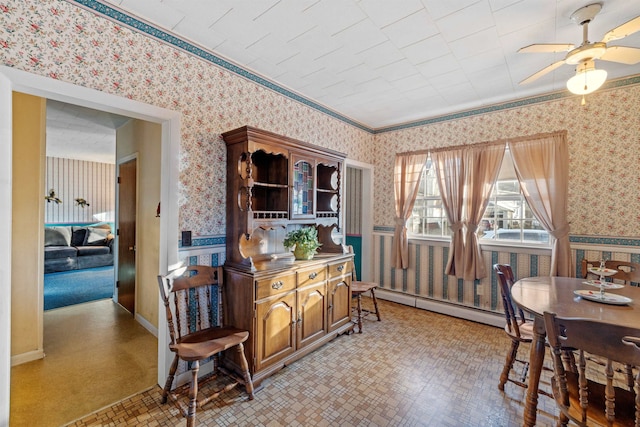 dining room featuring a baseboard radiator, ceiling fan, and crown molding