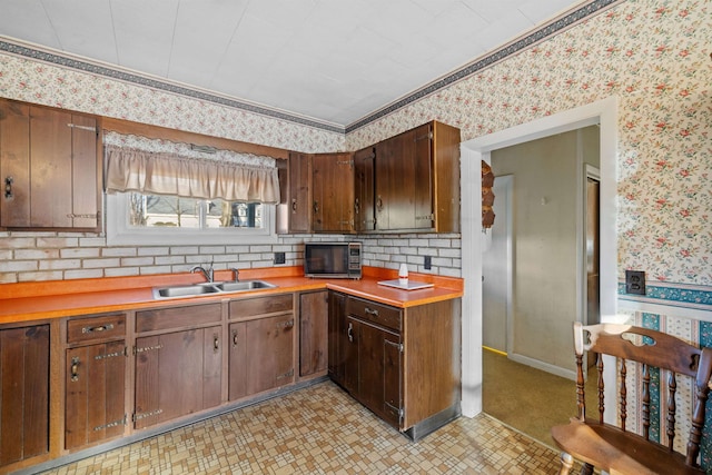 kitchen featuring dark brown cabinets and sink