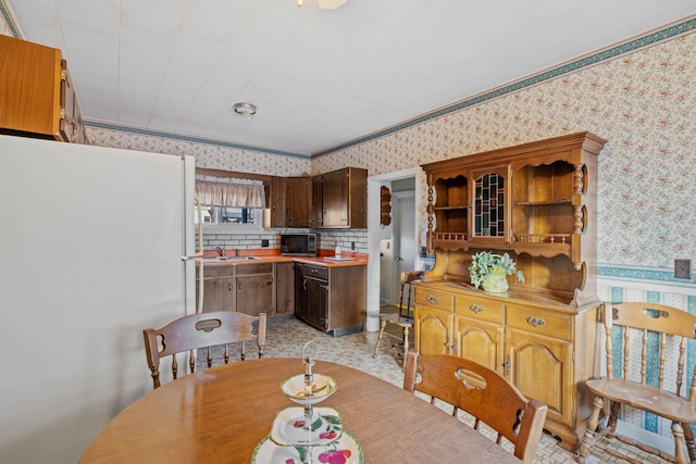 dining area with ornamental molding and sink