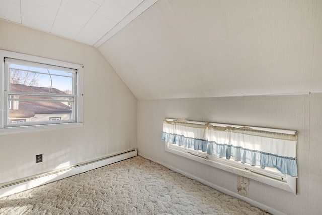 additional living space featuring carpet flooring, vaulted ceiling, and a baseboard heating unit