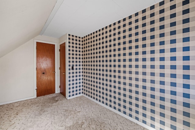 bonus room with carpet and vaulted ceiling