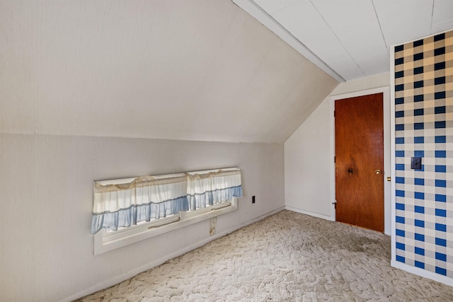 additional living space with lofted ceiling and light carpet