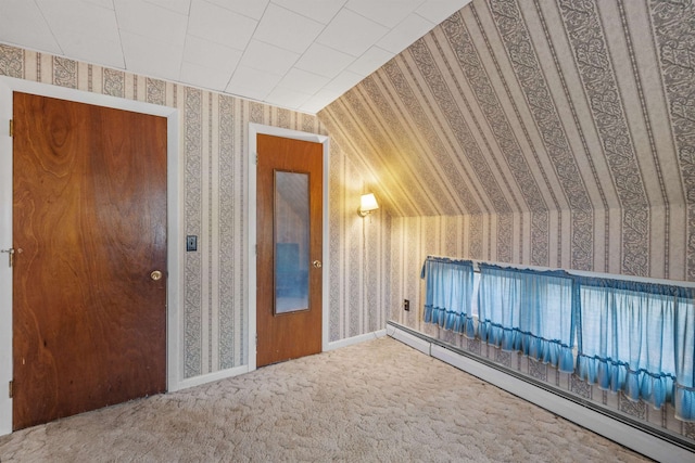 interior space with vaulted ceiling and a baseboard radiator