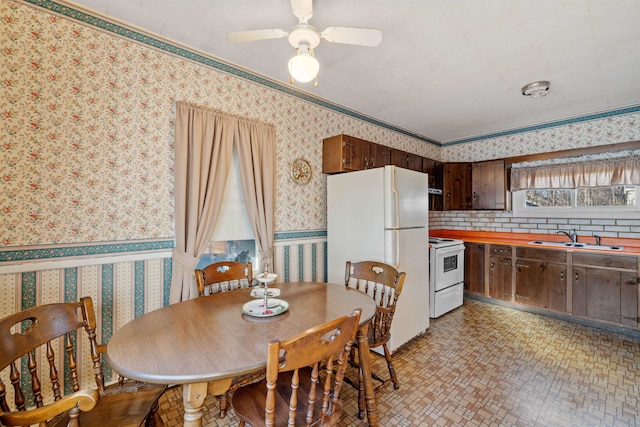 dining room featuring ceiling fan, ornamental molding, and sink