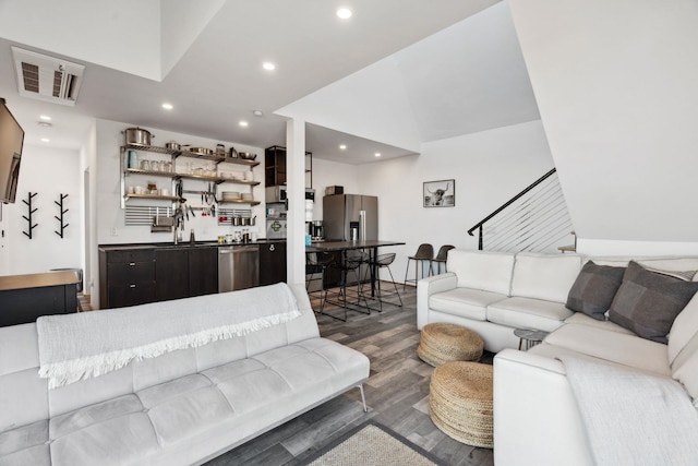 living room with vaulted ceiling and dark wood-type flooring