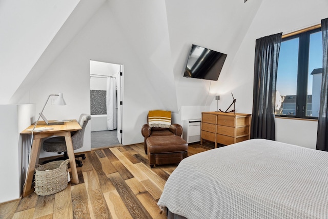 bedroom featuring lofted ceiling and wood-type flooring