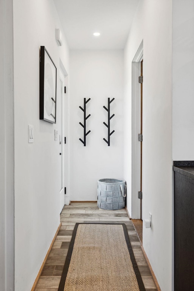 hallway with light hardwood / wood-style floors