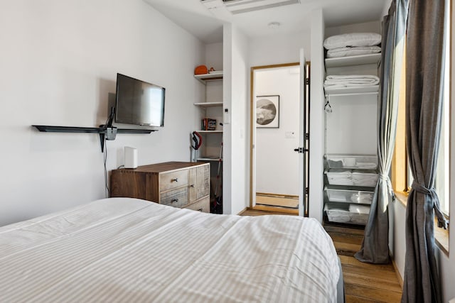 bedroom featuring light hardwood / wood-style floors and a baseboard radiator