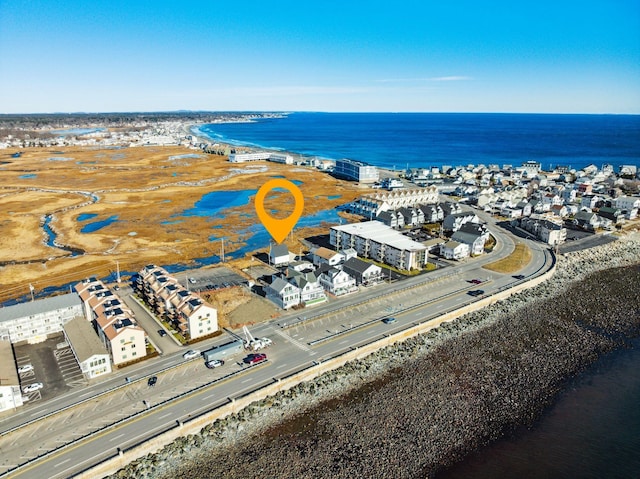 birds eye view of property featuring a water view and a view of the beach