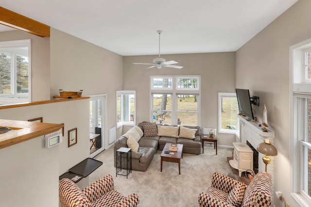 carpeted living room with ceiling fan