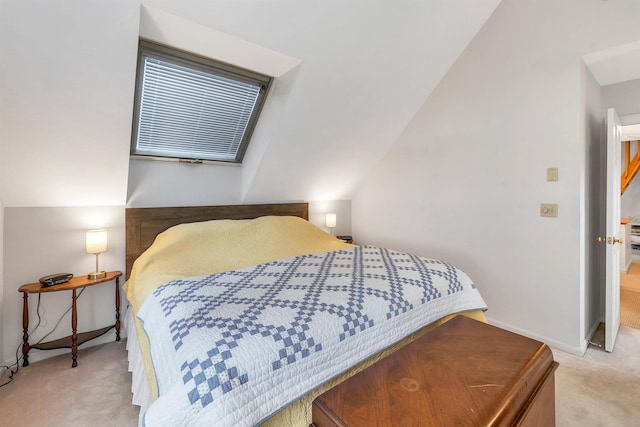 carpeted bedroom with vaulted ceiling