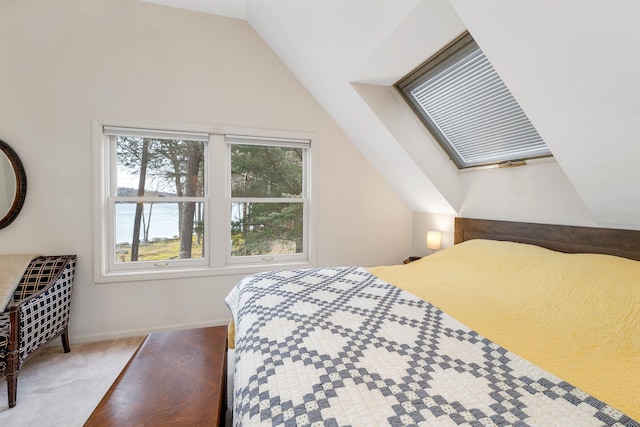 bedroom featuring a water view and vaulted ceiling