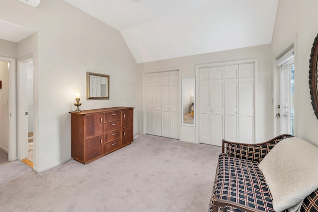 living area featuring light carpet and vaulted ceiling