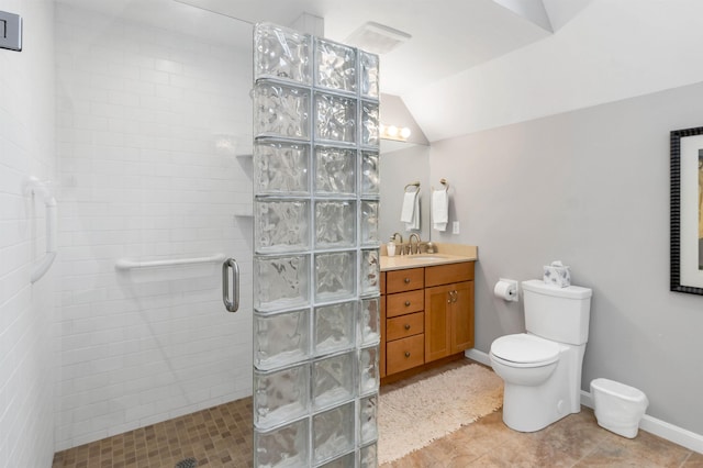 bathroom with a shower with door, vanity, vaulted ceiling, and toilet