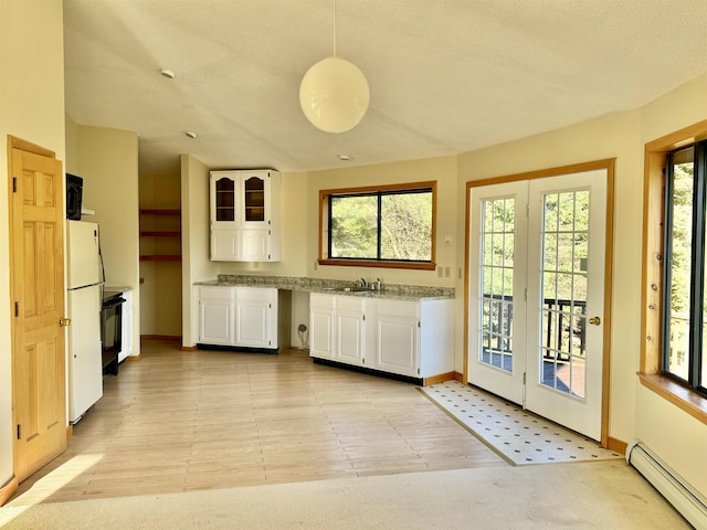 kitchen featuring white cabinetry, sink, a baseboard radiator, white fridge, and pendant lighting