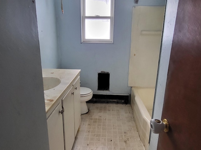 bathroom featuring vanity, a bath, and toilet