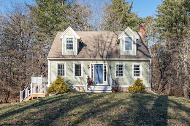 cape cod-style house with a front yard