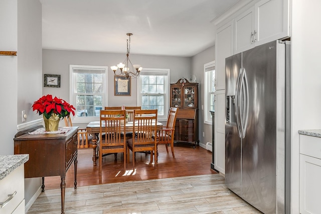 dining room featuring plenty of natural light and an inviting chandelier