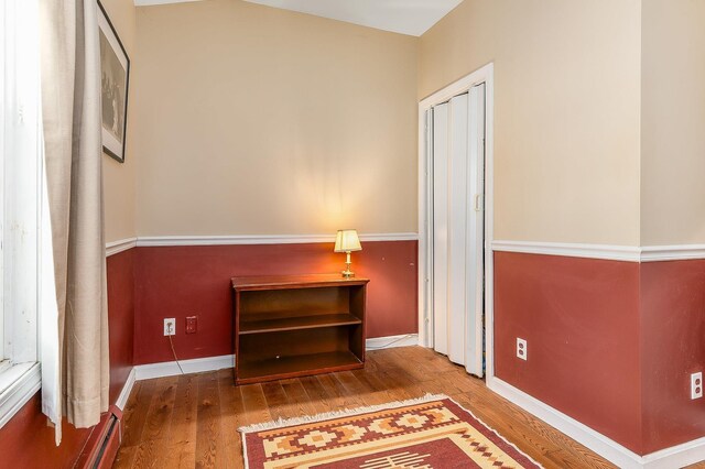 interior space featuring baseboard heating and hardwood / wood-style flooring