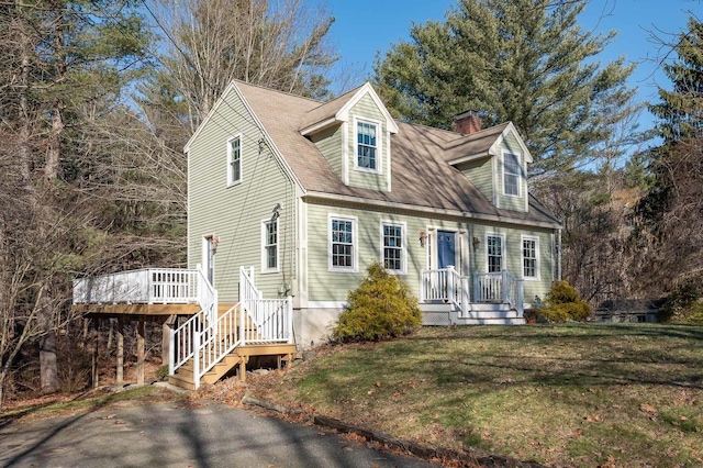 new england style home featuring a front yard