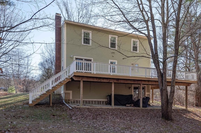 back of property featuring a wooden deck