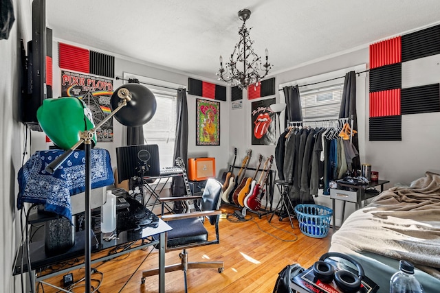 bedroom featuring hardwood / wood-style floors, a chandelier, and ornamental molding