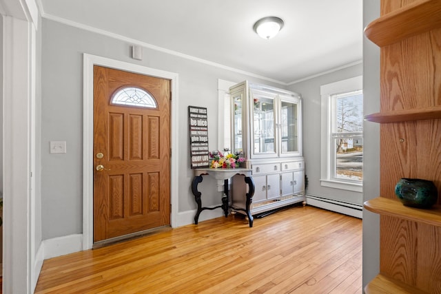 entryway with light hardwood / wood-style floors, ornamental molding, and baseboard heating