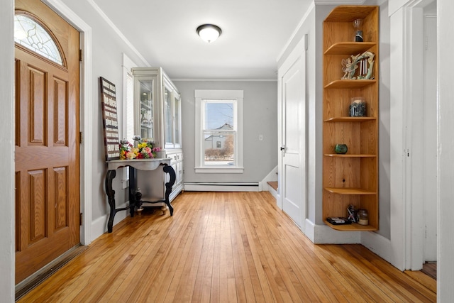 foyer entrance with a baseboard radiator, light hardwood / wood-style flooring, and ornamental molding