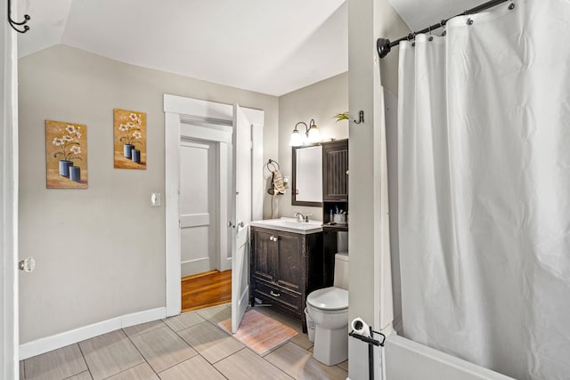 full bathroom featuring shower / bath combination with curtain, vanity, toilet, and lofted ceiling