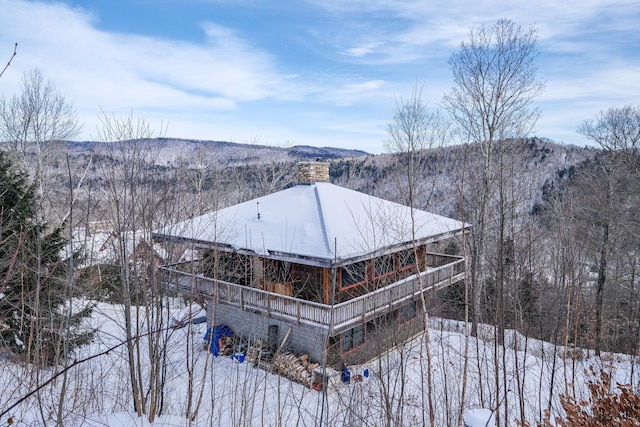 snow covered structure with a mountain view