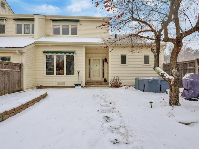 view of snow covered rear of property