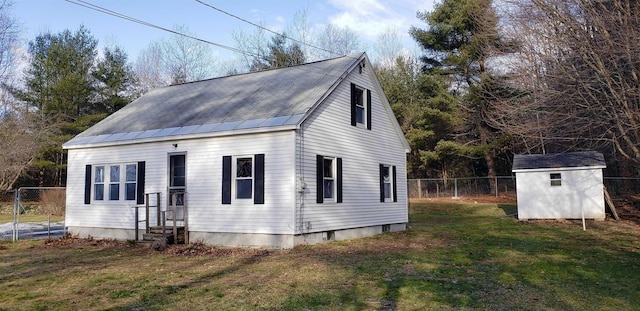 view of front of house with a shed and a front yard