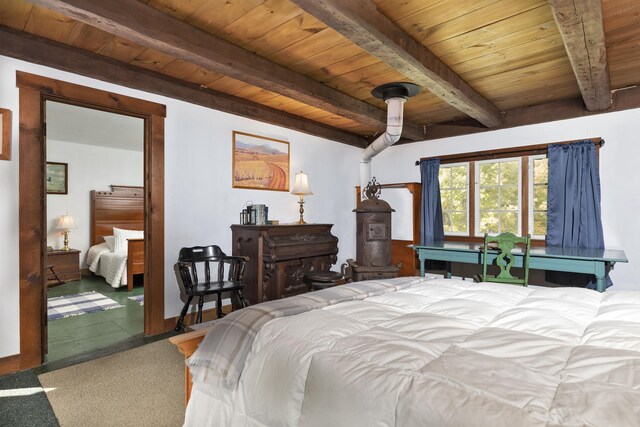 61 Crosby Rd, Topsham, VT 05076 - bedroom featuring ceiling fan, beam ceiling, wood ceiling, and a wood stove