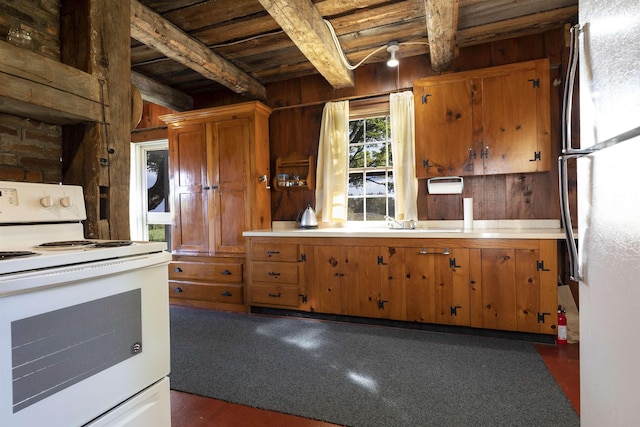 kitchen with beam ceiling, white appliances, wooden ceiling, and wooden walls