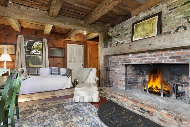 61 Crosby Rd, Topsham, VT 05076 - interior space featuring beam ceiling, wooden ceiling, a brick fireplace, wood walls, and hardwood / wood-style flooring