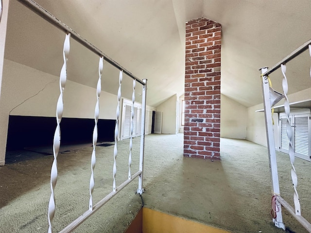 interior space featuring carpet and vaulted ceiling