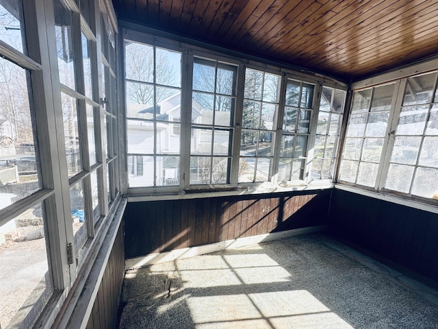 unfurnished sunroom featuring wood ceiling