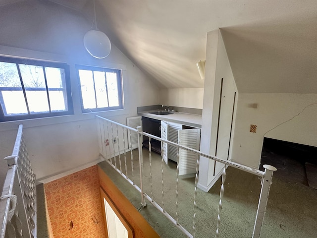 interior space with sink and vaulted ceiling