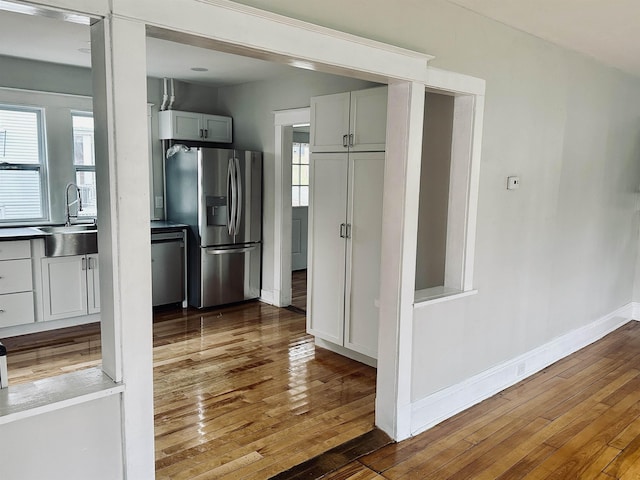 kitchen with a wealth of natural light, sink, dark hardwood / wood-style floors, and appliances with stainless steel finishes